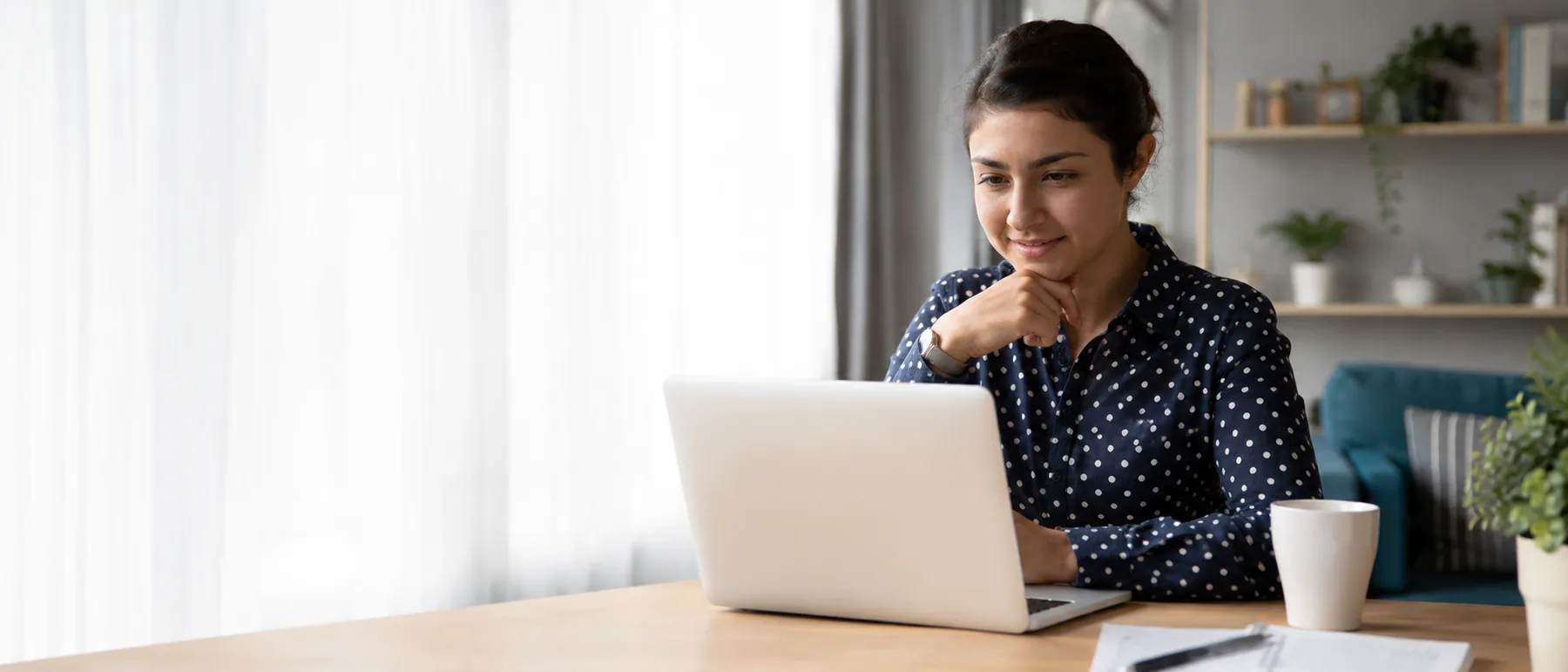 A woman taking part in an online counselling session from home